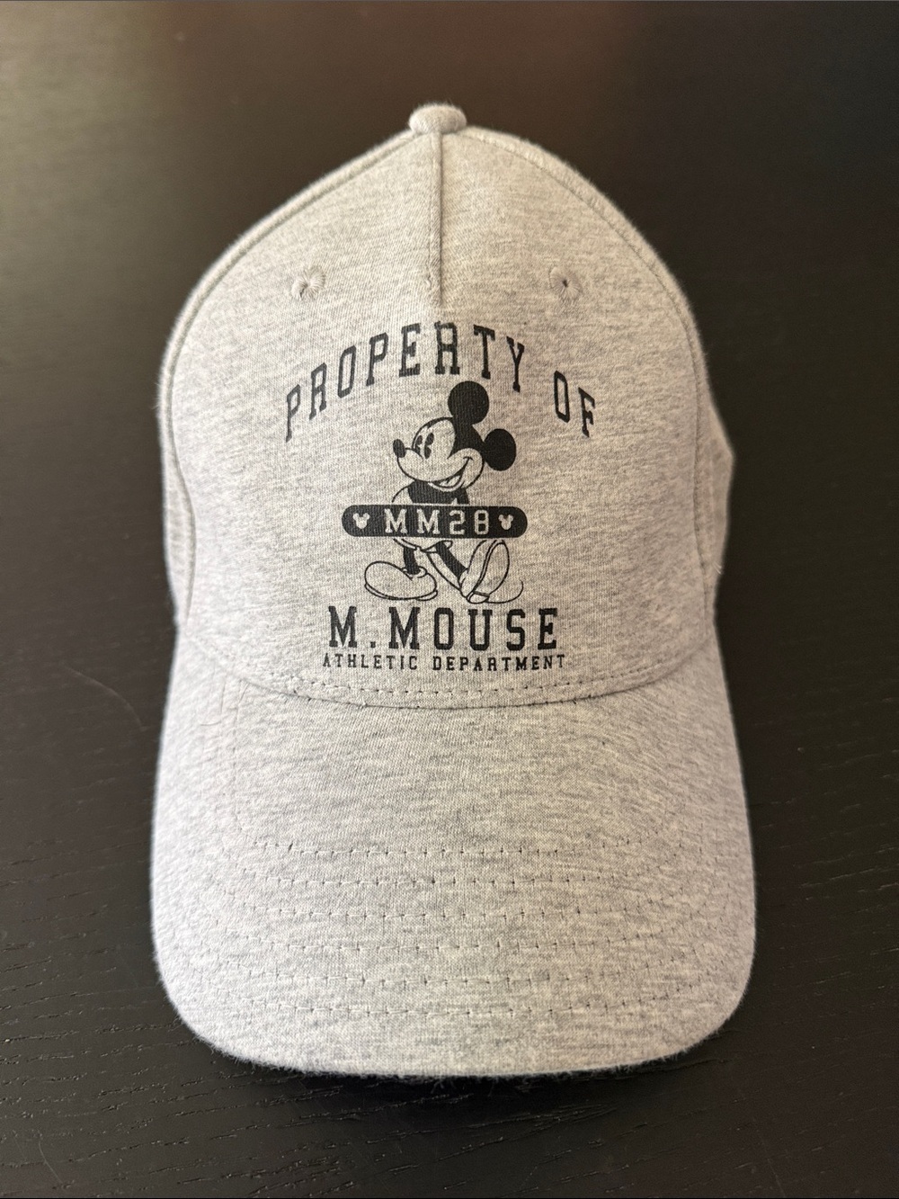 Disney’s Mickey Mouse baseball cap hat. Gray with black logo.